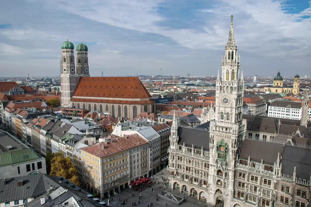 Blick über die Münchner Altstadt auf die Frauenkirche mit ihren grünen Kupferkuppeln und das Neue Rathaus am Marienplatz